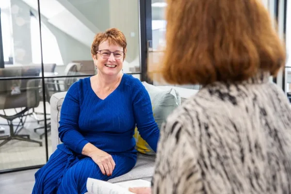 Ashfold Consulting – Linda Gent – Mediation An over the shoulder shot of Linda Gent smiling and working with a client.