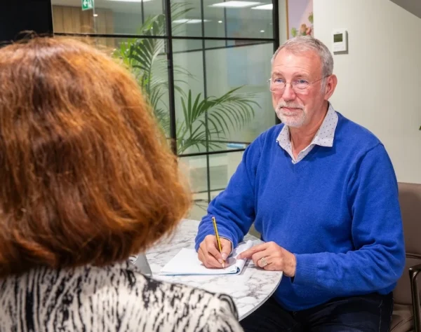 Ashfold Consulting Mediation Services Andrew Gent Image of Andrew Gent at a table, working with a client.