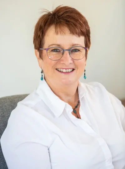Image of Andrew Gent at a table, working with a client. 