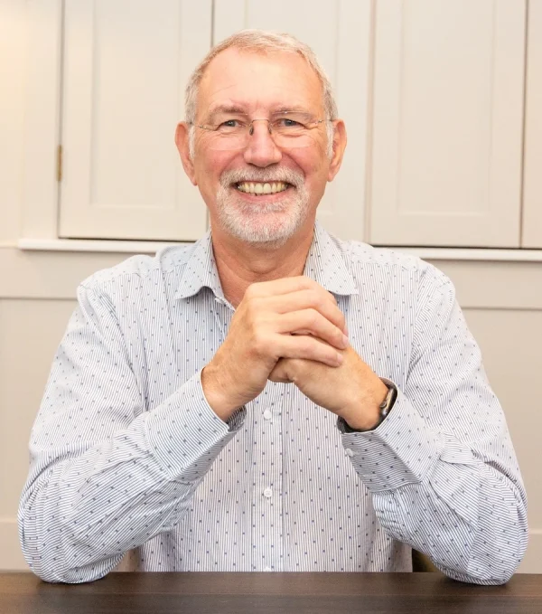 Image of Andrew Gent at a table, working with a client. 
